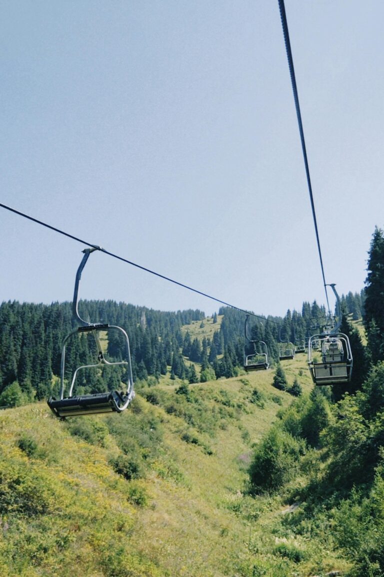 A tranquil chairlift ride over lush green hills in Talgar, Almaty Region, Kazakhstan.